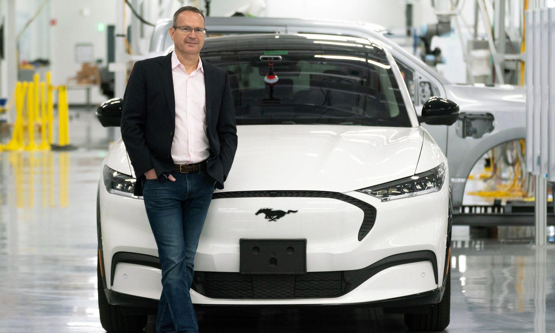 A man standing in front of a car